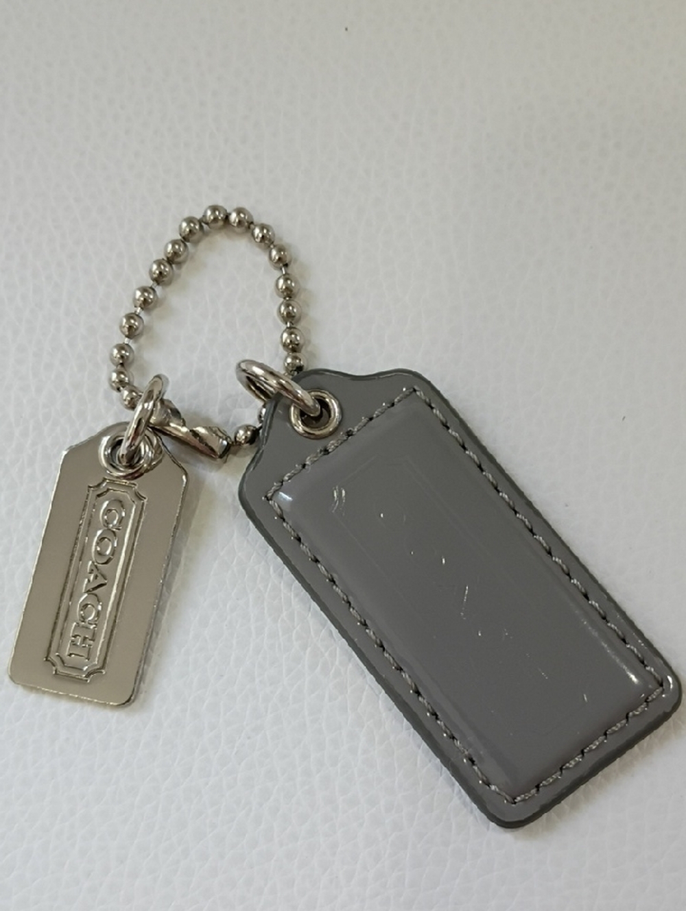 Coach Gray Patent Leather Key Tag with Polished Metal Logo Charm